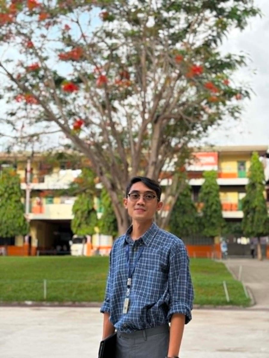 Byron Chu, RN, standing on his university campus